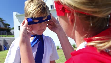 Mother-adjusting-mask-of-her-son-in-garden-4k