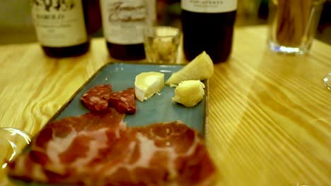 wine and cold cuts on a wooden table