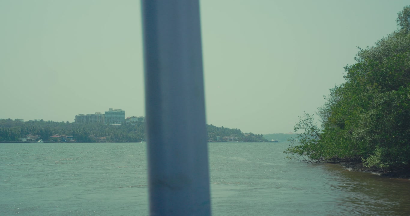 River scene with pole in foreground and distant shoreline with trees calm outdoor nature landscape