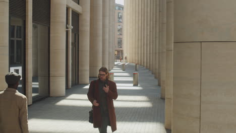 Businessman-Walking-in-Downtown-and-Making-Phone-Calls