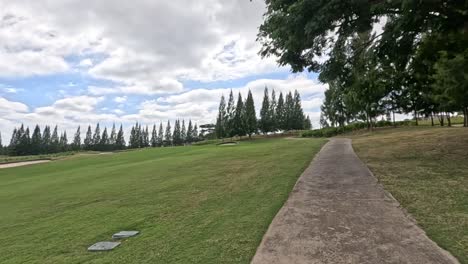 scenic golf course with trees and pathway