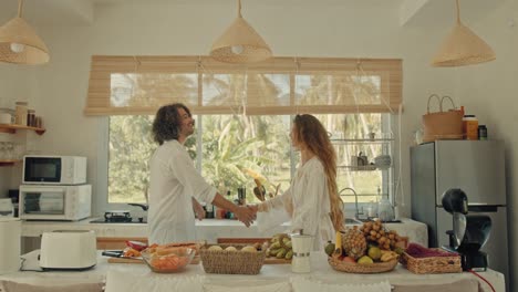 couple dancing in a tropical kitchen