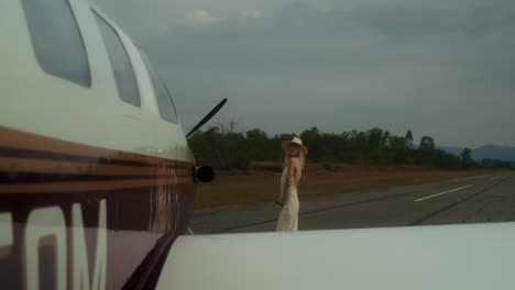 woman at airport near airplane