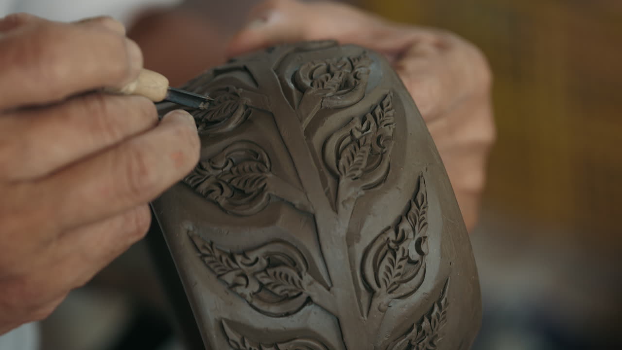 Artisan creating intricate clay designs