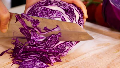 slicing cabbage on a wooden cutting board