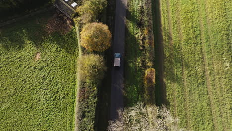 land drover driving through country road from above