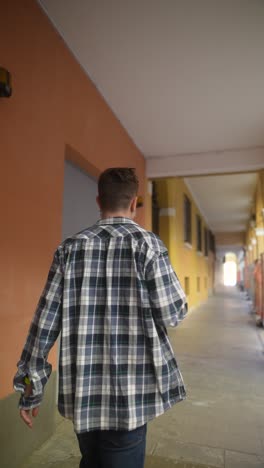 man walking through a city corridor