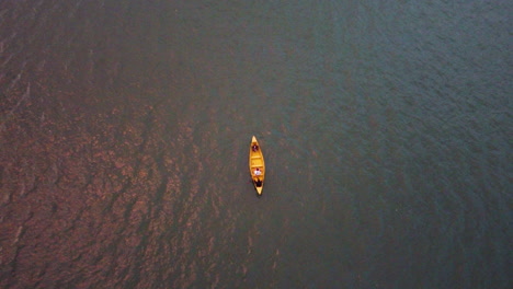 boating - wooden boat floating in the lake in nepal