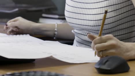 woman working on architectural drawings