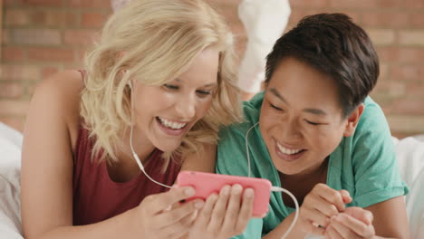 girl friends listening to music sharing smart phone