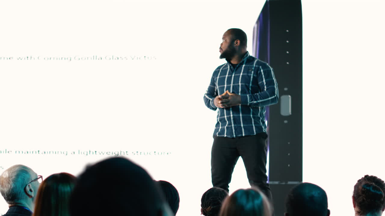 African american lead engineer revealing new smartphone launch with presentation