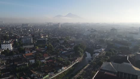 aerial view of downtown yogyakarta, river, buildings, houses and small streets shot in the morning