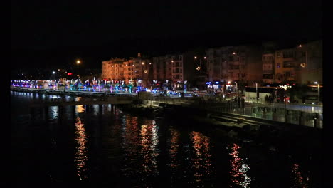 port of a coastal city and the lights of the objects on it at night