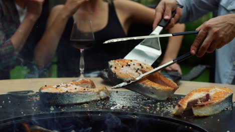 unrecognizable man cooking food for grill party. man chef using kitchen tools