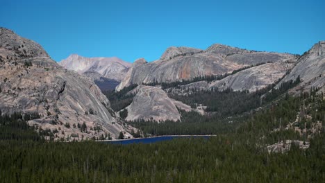 tioga lake pass yosemite national park west portal entrance wilderness forest rugged rocky formation terrain california lee vining forest sunny blue sky clouds sierra nevada mountains landscape static