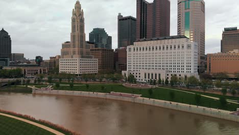 rising aerial showing neat looking city center of columbus with tall buildings