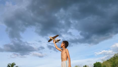 boy playing with a paper airplane