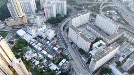 downtown hong kong daily traffic surrounded with city skyscrapers, aerial view