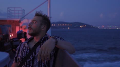 Young-man-looking-at-the-sea-at-night.