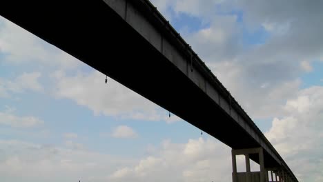 A-time-lapse-shot-of-a-raised-bridge--with-clouds-behind