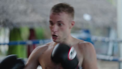 men training or sparring in a boxing ring