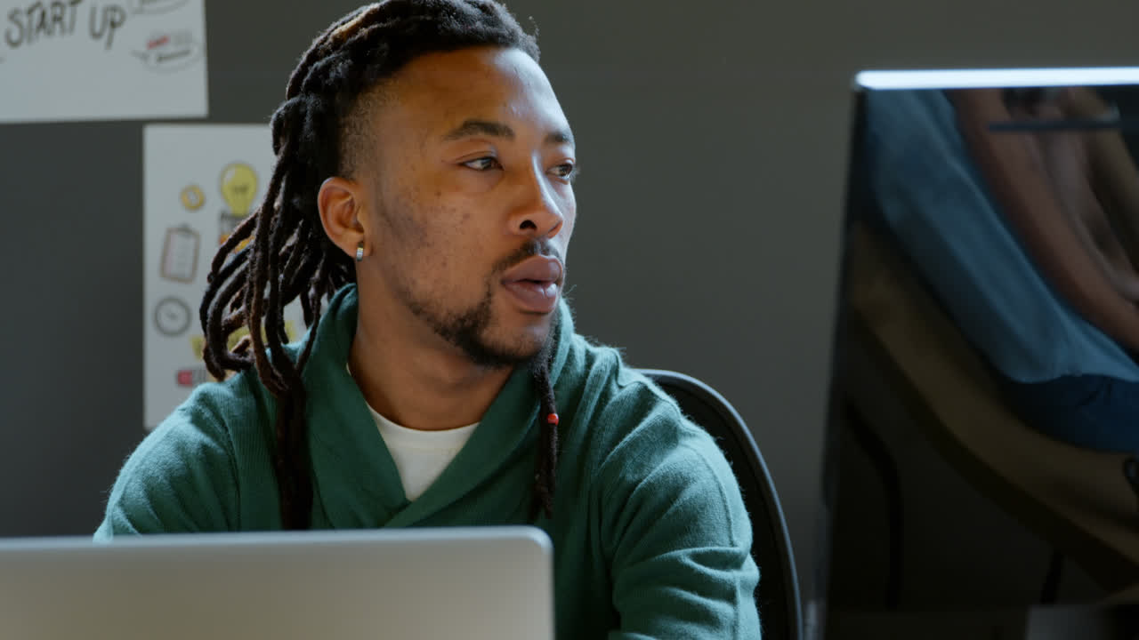 Male executive working at desk in office 4k