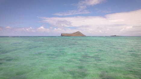 Nature's-perfection-is-evident-as-the-stone-sand-beach-meets-the-radiant-hues-of-the-turquoise-sea-in-Hawaii