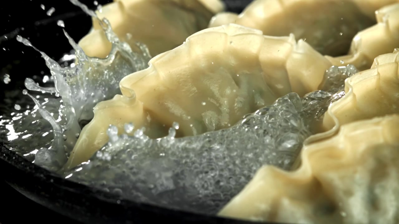 Dumplings Cooking in a Pan with Splashing Boiling Water
