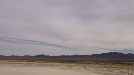 Willcox-Playa-in-Arizona-is-an-ancient-lake-bed-with-silhouetted-mountain,-desert-landscape-aerial