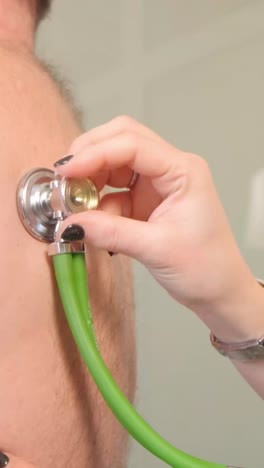 a professional doctor listens to the work of the heart with the help of a stethoscope. medical examination in the clinic.