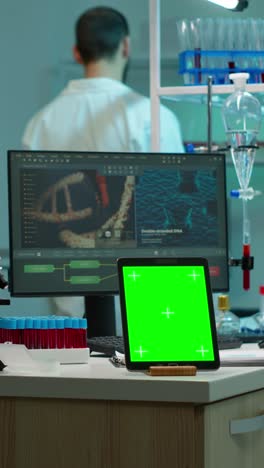 vertical video: tablet with green chroma key screen placed on desk in lab