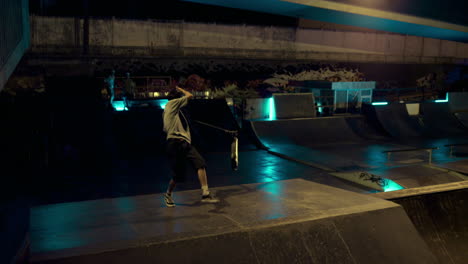 Sporty-teenage-riders-jumping-together-on-scooter-and-bmx-bike-at-skatepark.