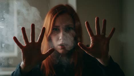 a woman confronts her reflection through a foggy, cracked glass, capturing the essence of isolation and introspection