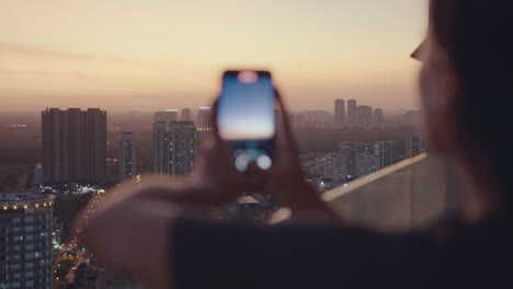 european girl take photo sunset