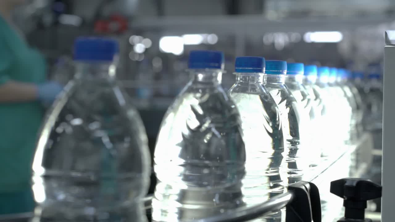 Water Bottles on a Conveyor Belt in a Bottling Plant