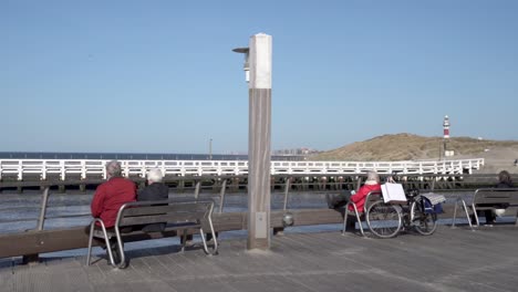 people enjoying the view at the eastern palisade, nieuwpoort, belgium, wide shot