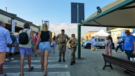 people interacting with military personnel in sorrento