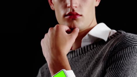 Androgynous-man-posing-against-black-background