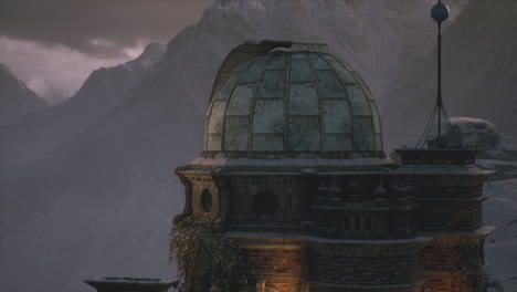 Mountain observatory surrounded by snow capped peaks at dusk