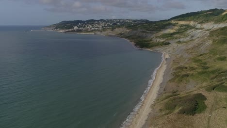 aerial on the edge of charmouth tracking forwards along the coast towards lyme regis