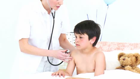 doctor listening with a stethoscope to little patients lungs