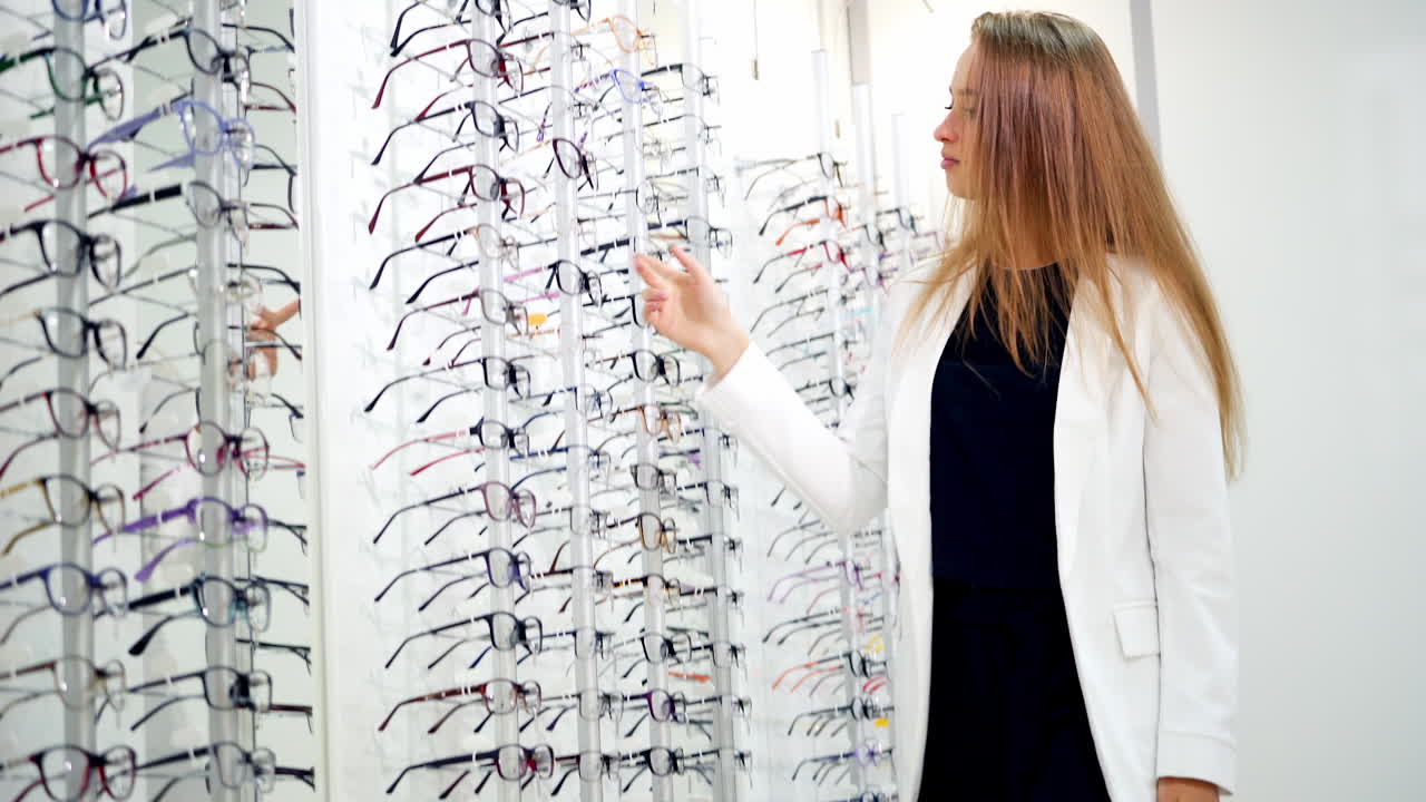 Various of eye glasses in the shop. Eyeglasses on display shelves in glasses store