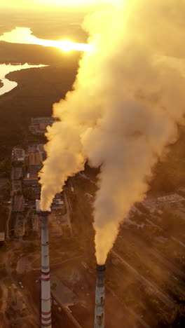 smoke from industrial chimney. air pollution by smoke coming out of two factory chimneys vertical video