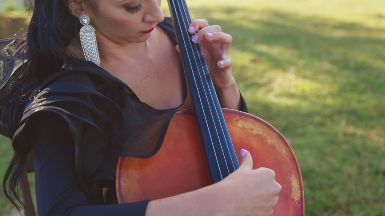Woman playing cello outdoors