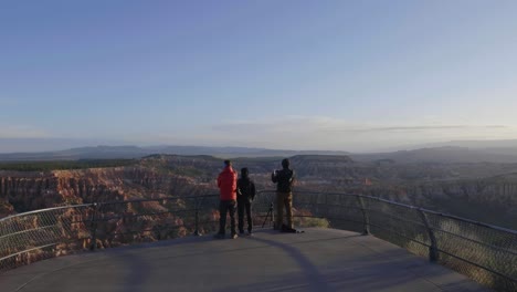 tourists on the overlook at bryce point during sunrise in slow motion