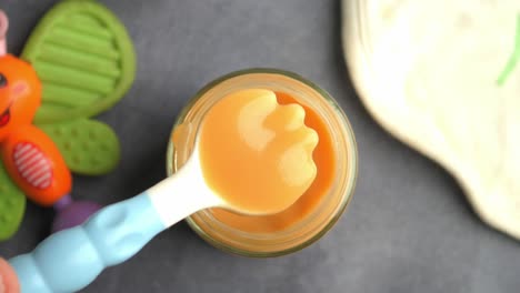 baby food in glass jar with spoon