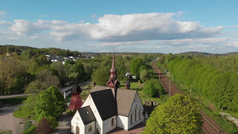 4k aerial footage rising over the lerum kyrka church in the town of lerum in vastra gotaland, sweden