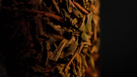 black long-term tea brewed in french-press glass column - close-up