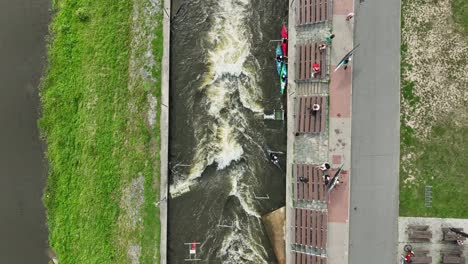 shot from a height from a drone on the wild canal of the river where kayakers skid the water