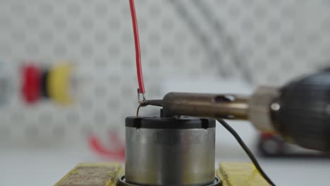 hand soldering small black and red wires